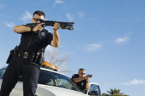 Police Officers Aiming With Gun