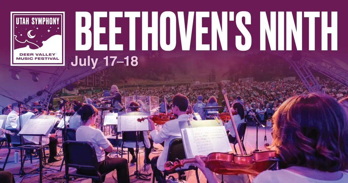 Outdoor orchestra on a stage performing Beethoven's Ninth at the Deer Valley Music Festival; festival branding is visible in the corner.