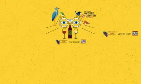 Whimsical yellow poster showing birds perched on oversized glasses around a wine bottle and two wine glasses, with sponsor logos nearby.
