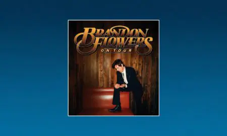 Brandon Flowers On Tour poster featuring a man in a suit posing on a red bench against wooden panel backdrop.