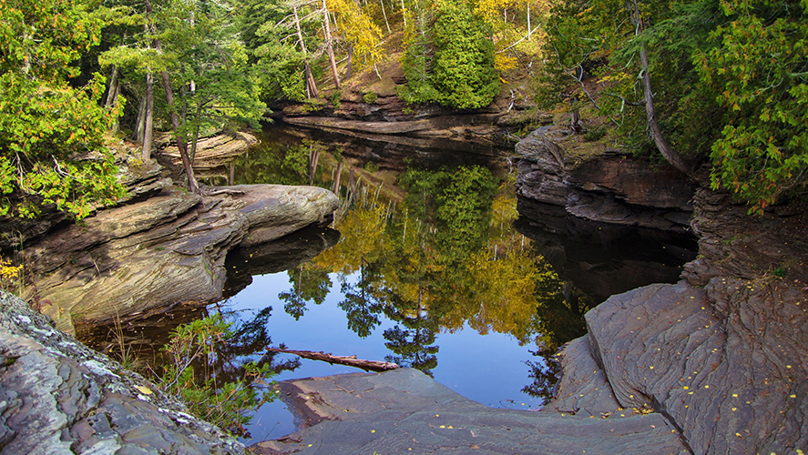 Fall colors reflected in a lagoon in the Porcupine Mountains State Park in Michigan's Upper Peninsula wilderness
