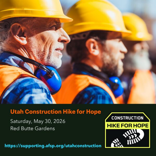 Group of construction workers in yellow hard hats and orange vests, with a banner for 'Utah Construction Hike for Hope' dated May 30, 2026 at Red Butte Gardens.