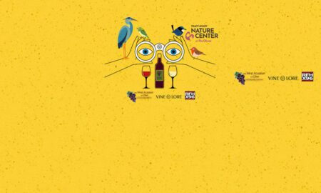 Whimsical yellow poster showing birds perched on oversized glasses around a wine bottle and two wine glasses, with sponsor logos nearby.